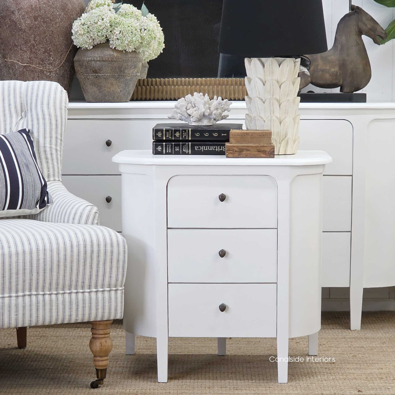 Creemore 3 Drawer Bedside in White displayed in a living space, showing its light, fresh finish and refined three-drawer layout.