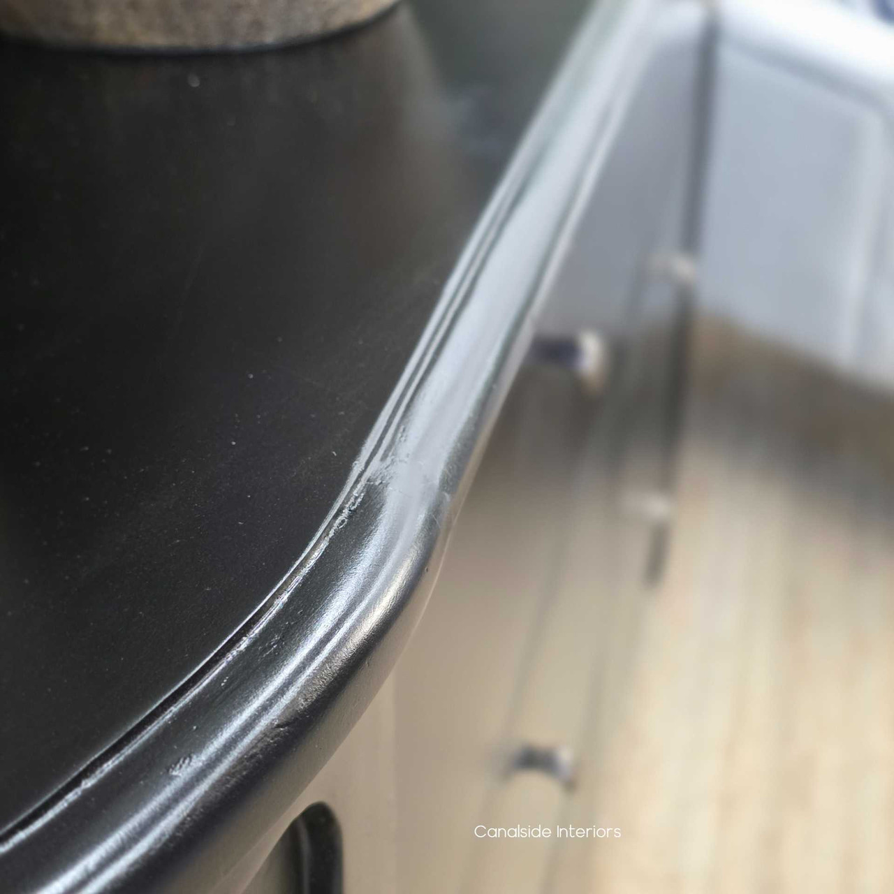 Close-up of the Creemore Chest’s top edge in black, highlighting the rounded profile and subtle distressing along the trim.