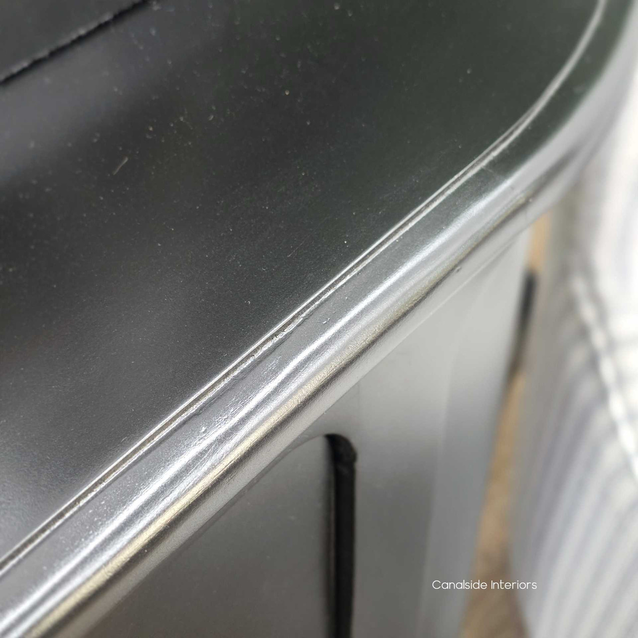 Detail shot of the Creemore 6 Drawer Chest in Black, capturing the gentle curve of the top edge and the refined craftsmanship of the painted timber surface.