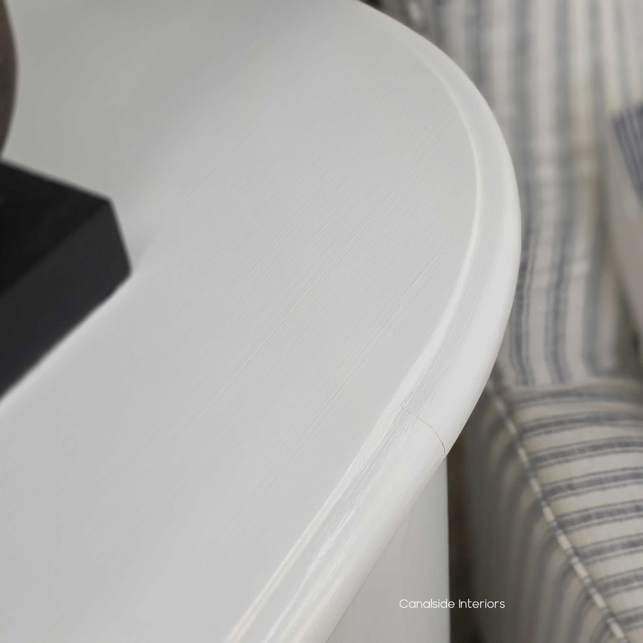 Close-up of the top edge on the Creemore Chest in White highlighting the curved contour and subtle distressing.