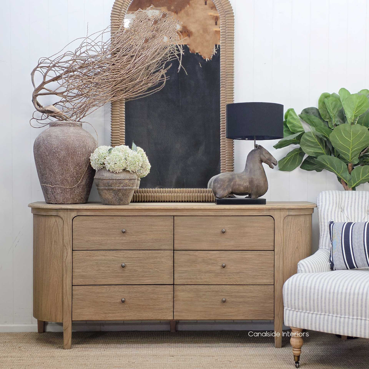 Front view of the Creemore 6 Drawer Chest in Weathered Oak, showcasing its six drawers, curved silhouette, and natural-toned finish.