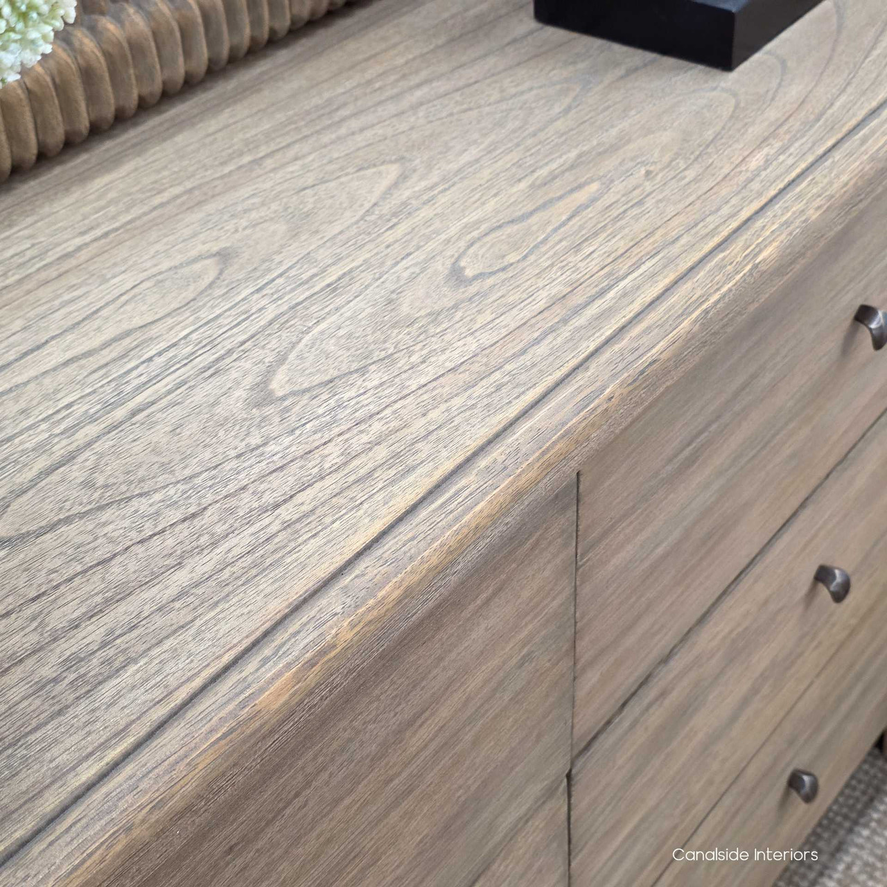 Detailed image of the chest’s top edge, highlighting the smooth rounded moulding and weathered texture.