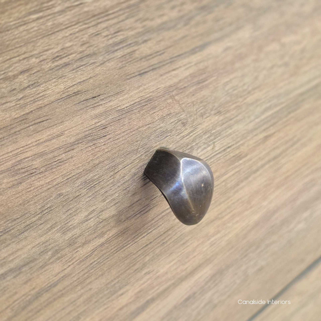 Hardware detail on the Creemore 6 Drawer Chest, showing the simple round knobs against the textured finish.