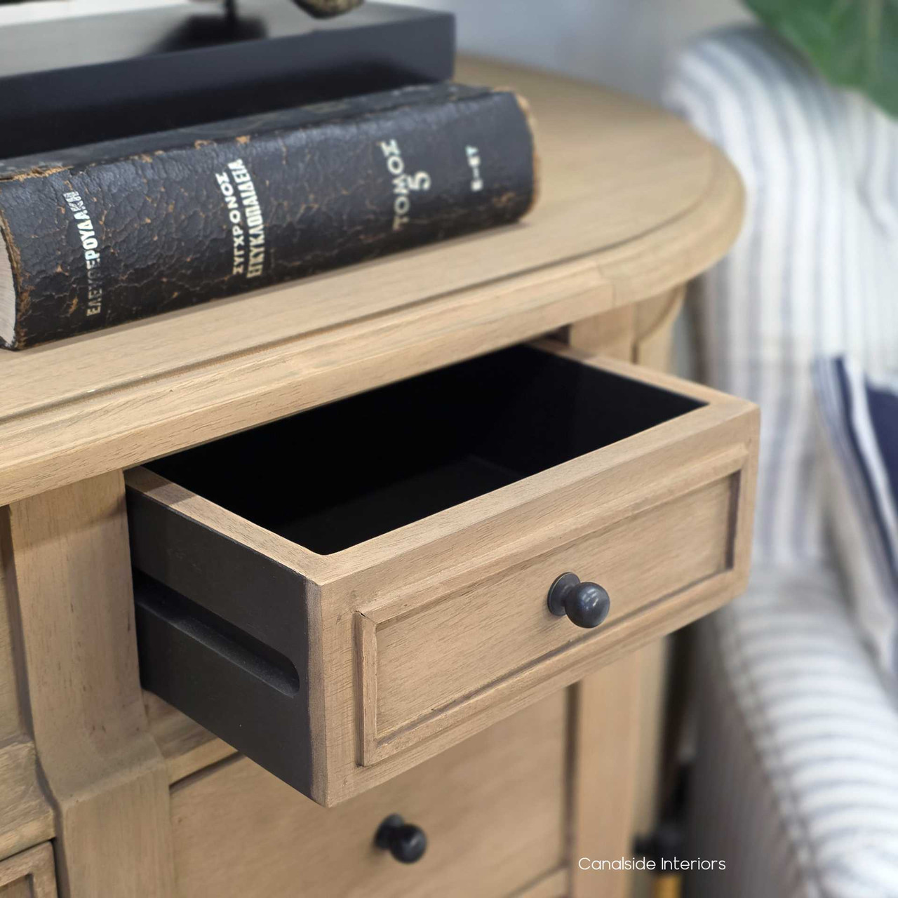 Close-up of Riverview Buffet drawer knob against the tonal wood finish with drawer slightly open.