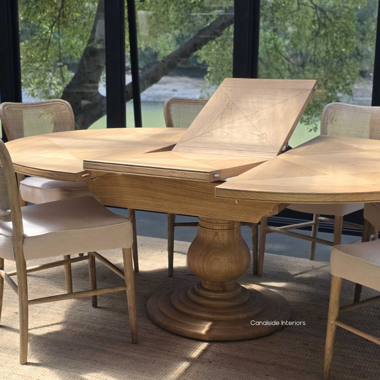 Close-up of the extension leaf in position, revealing the expandable parquet grain flow across the Sycamore table.