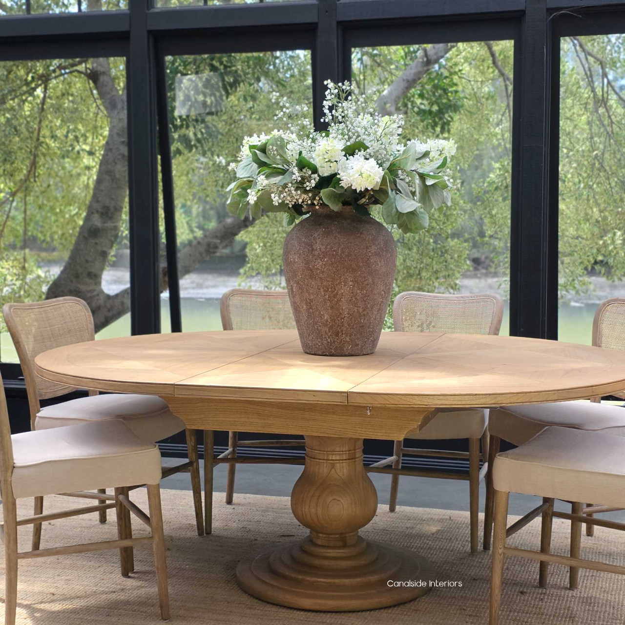 The Sycamore table expanded, perfect for gatherings around a natural cedar tabletop.