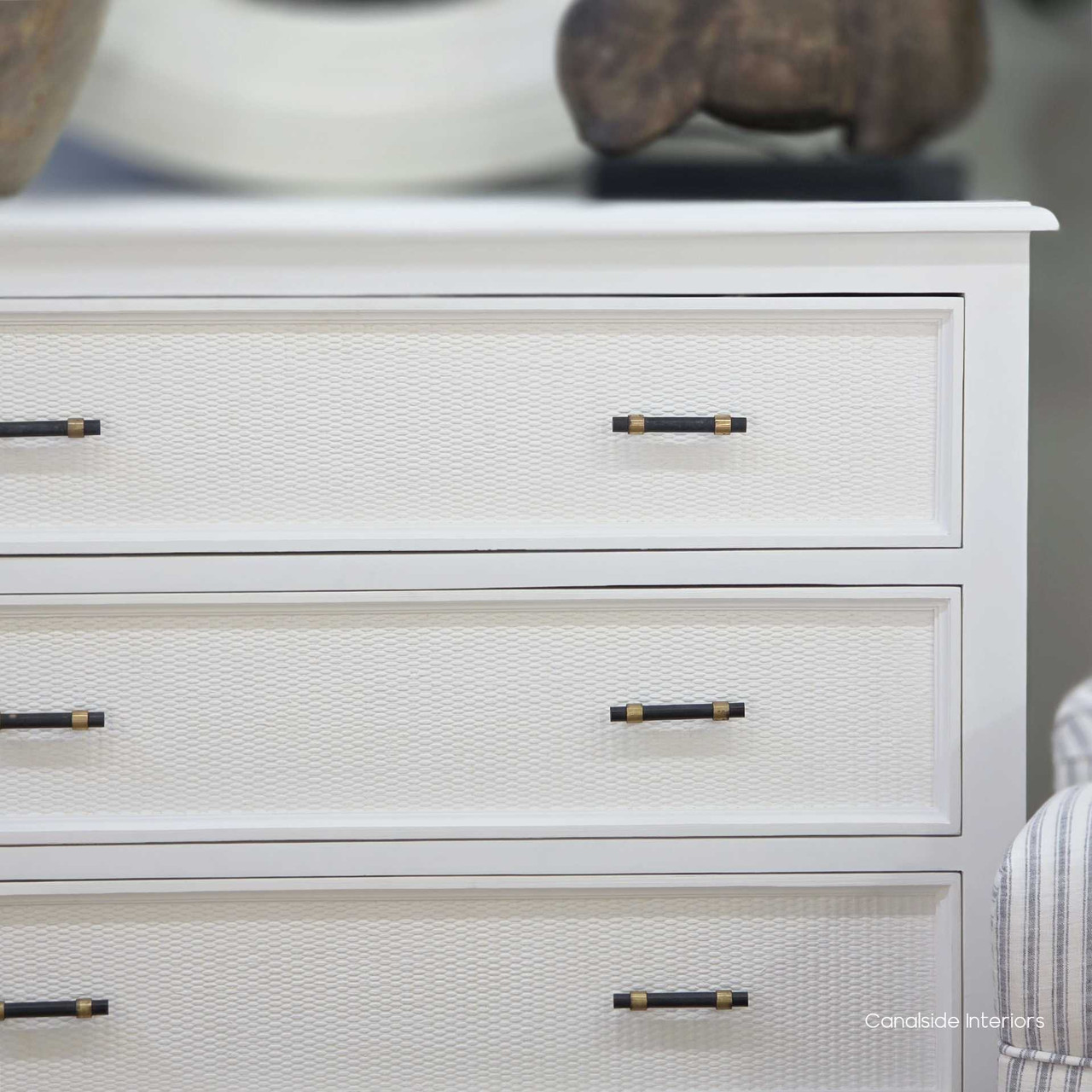 Close-up of the Brielle Rattan 3 Drawer Chest in white showing the fine woven rattan detailing and brass hardware on the drawer front.
