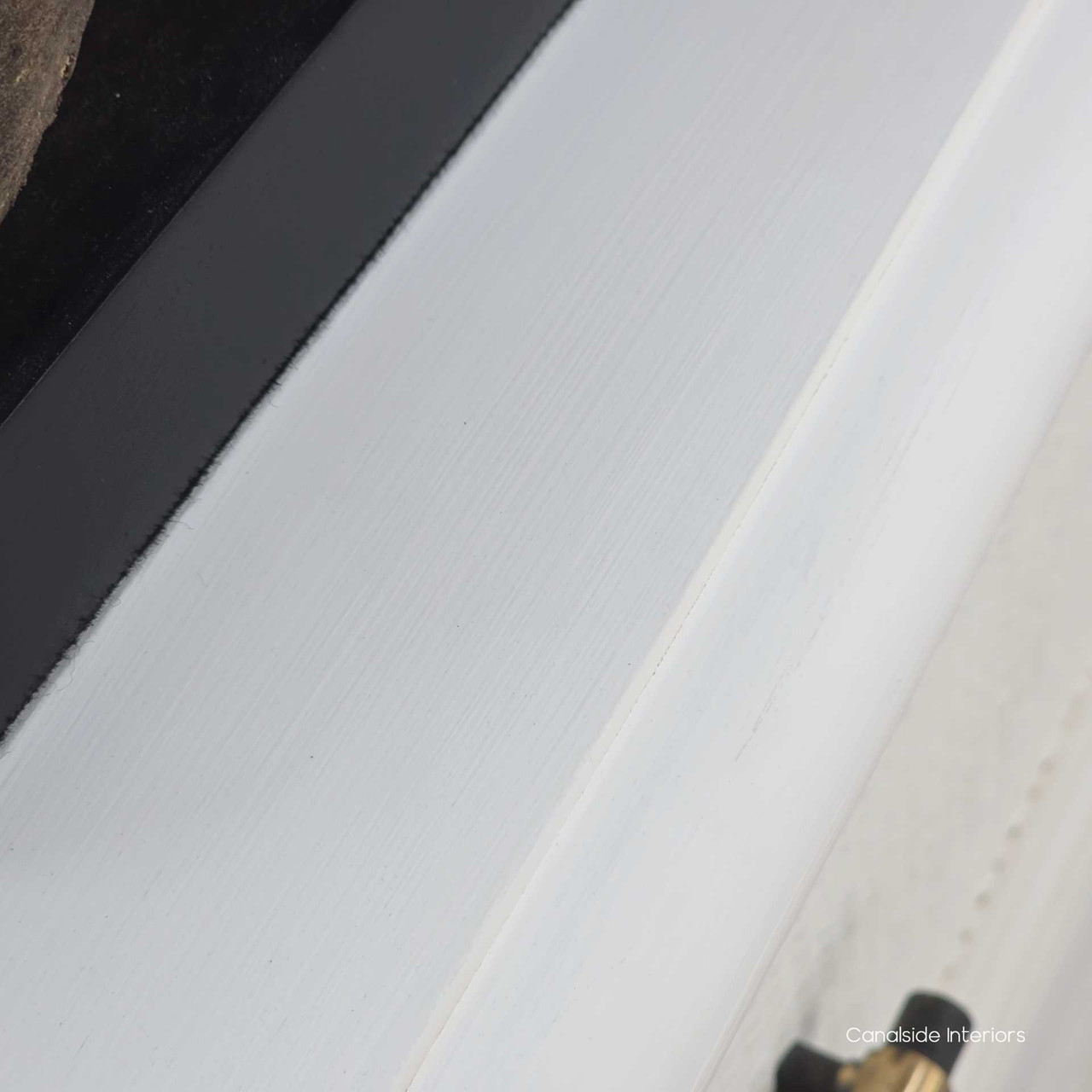 Top-down view of the Brielle Rattan 3 Drawer Chest in white highlighting the painted timber top styled with decor.