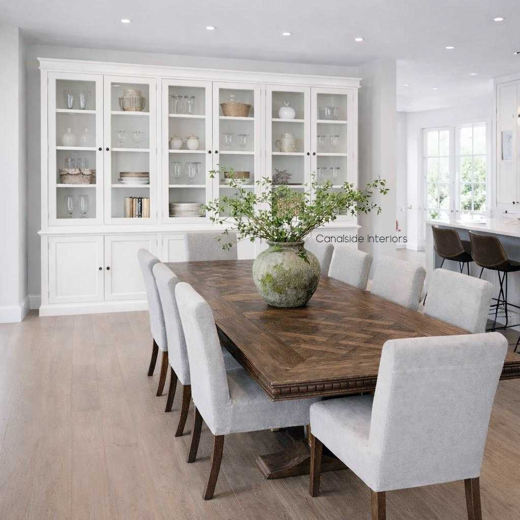Styled dining room view of the Grange 6 Glass Door Display Wall Unit in white shown in a Hamptons interior setting.