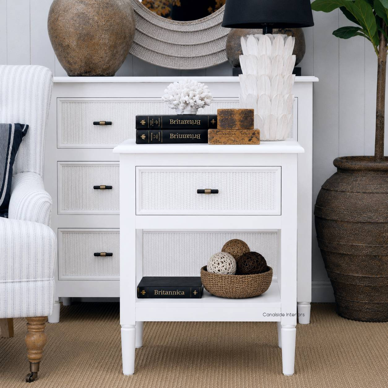 Front angle of the Black Brielle rattan 1 drawer side table bedside styled with a lamp and décor, showcasing the contrast between black timber and natural rattan texture.