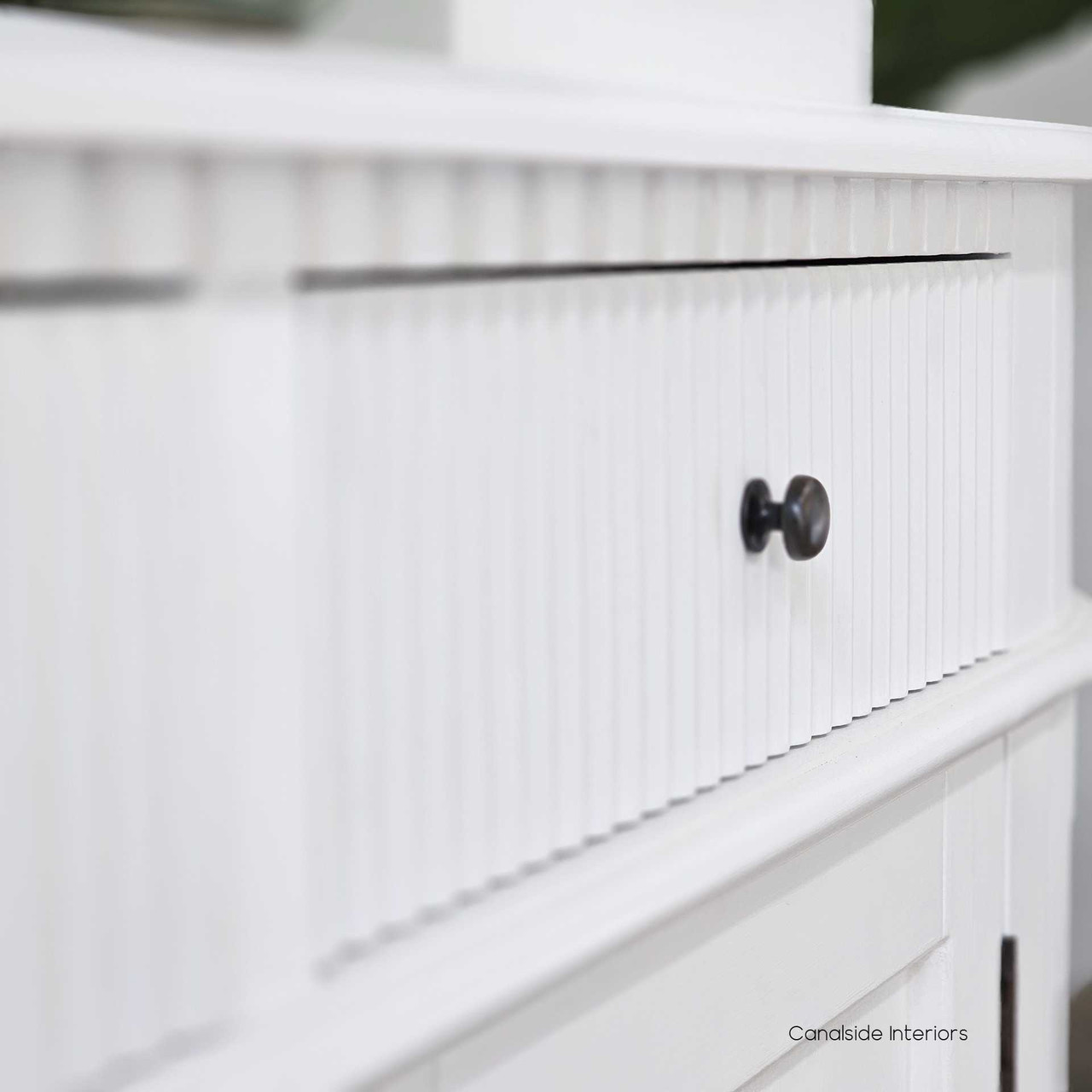 Close-up of the Louis Curved Sideboard’s ribbed fluting details, showcasing the intricate textural elements.
