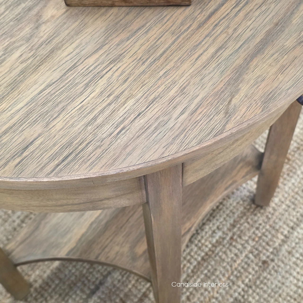 Natural Timber Demilune Side Table close-up featuring its warm finish and elegant curved front.