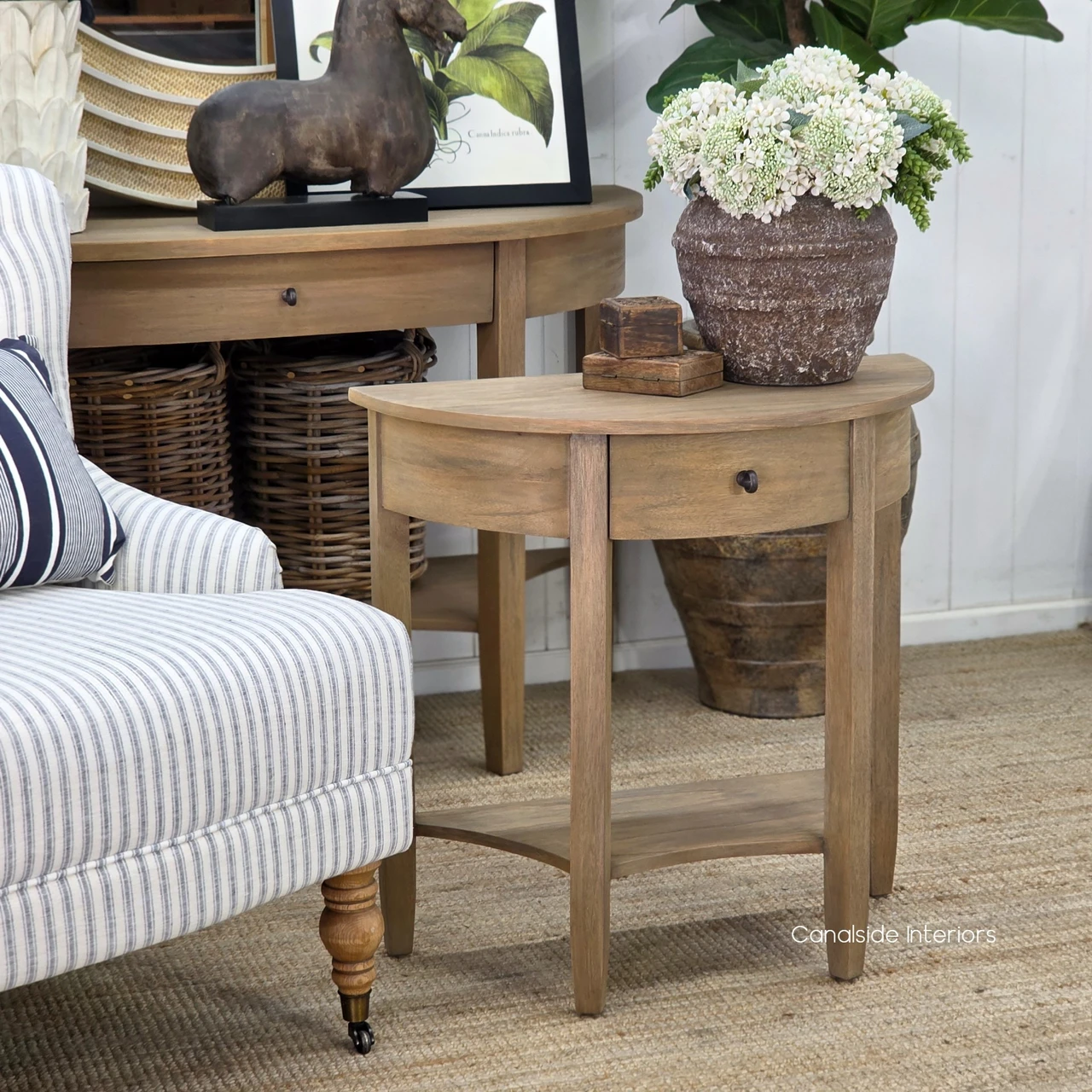 Luna Demilune Side Table viewed from the right, featuring softly curved edges and an open lower shelf.