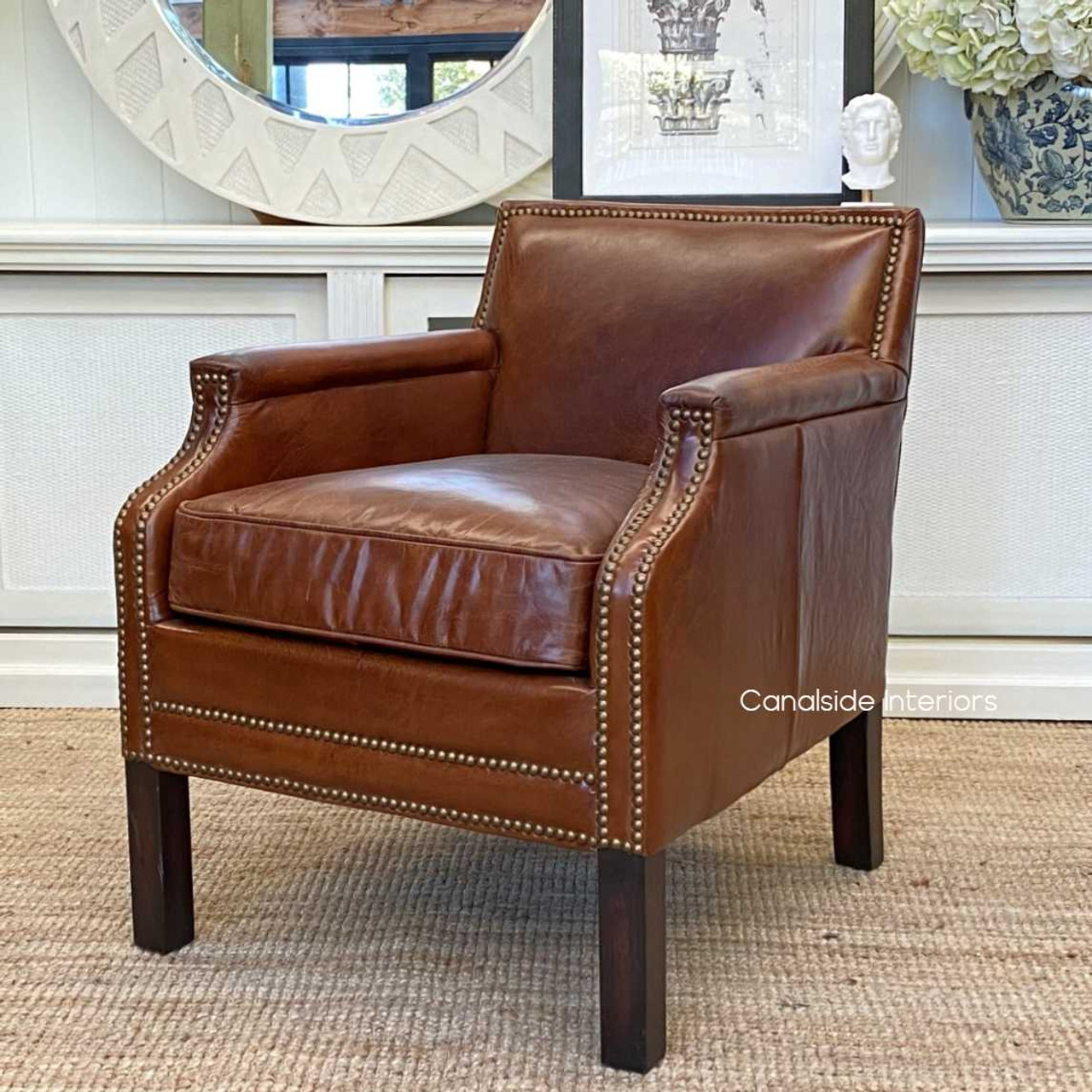 Side profile of the Metropolitan Armchair, emphasizing its sleek design and sturdy construction.