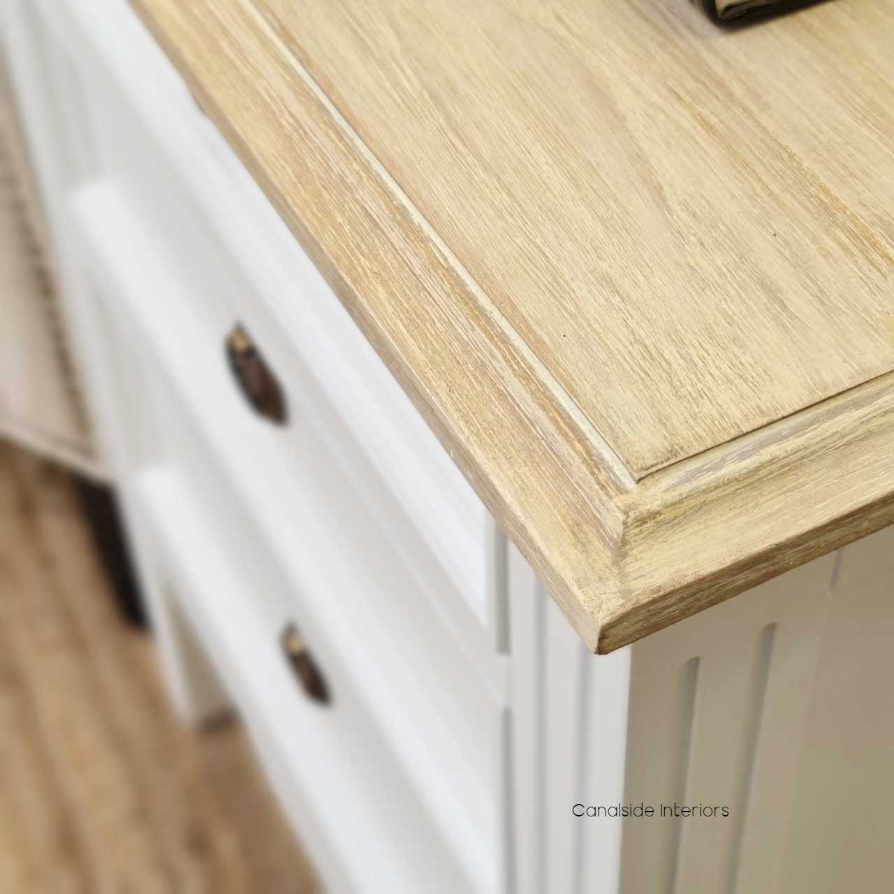 The bedside table's limewash top detail, offering a unique texture and contrast against the black finish.