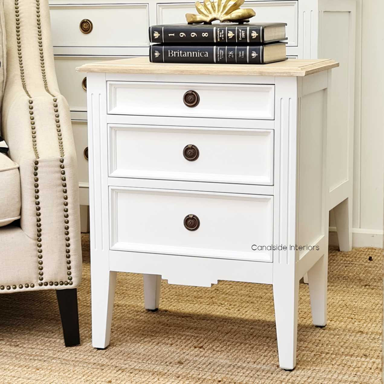 Styled within a Hamptons-inspired bedroom, the bedside table enhances the space with its understated elegance.