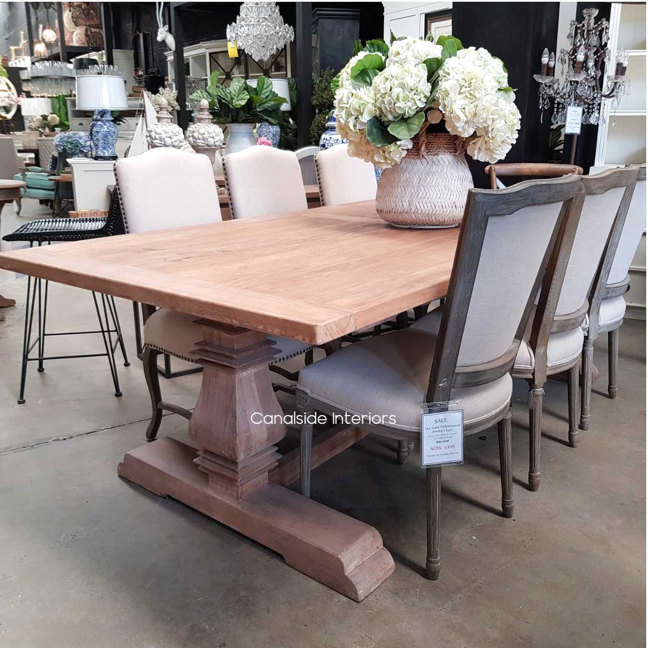 Angled perspective of the Artisan Dining Table, emphasizing its elegant design that fits into both luxurious and casual settings.