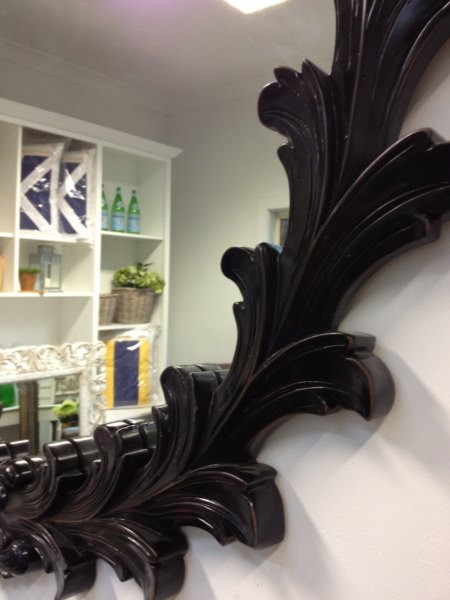 Close-up detail of the mirror's heavy distressing, highlighting the textural depth and artisanal quality of the patina.