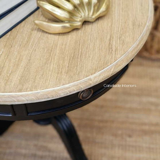 The Cobble Hill Round Table from Canalside Interiors, in sleek black with limewash highlights, is the embodiment of modern coastal sophistication for your bedroom decor