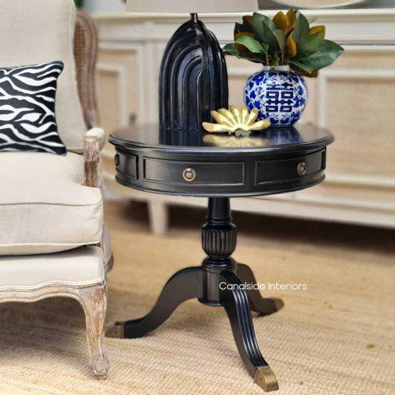 The Cobble Hill Side Table in distressed black is the epitome of timeless elegance, perfect for adding a classical touch to a Hamptons-style bedroom, brought to you by Canalside Interiors