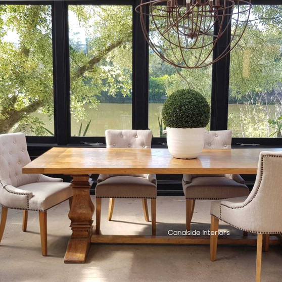 View of the Artisan Parquetry Top Dining Table, highlighting its recycled timber and elegant canon legs at Canalside Interiors.