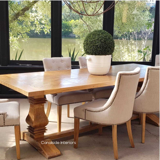 View of the Artisan Parquetry Top Dining Table, highlighting its recycled timber and elegant canon legs at Canalside Interiors.