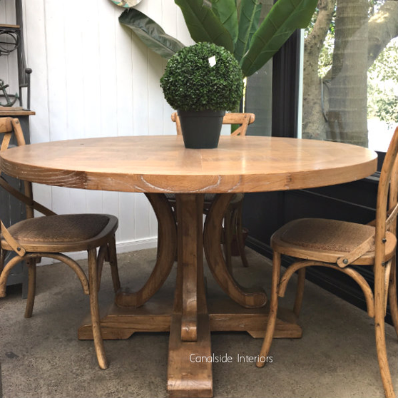 View of the Artisan Parquetry Top Round Dining Table at Canalside Interiors, showcasing its recycled timber and elegant parquetry top.