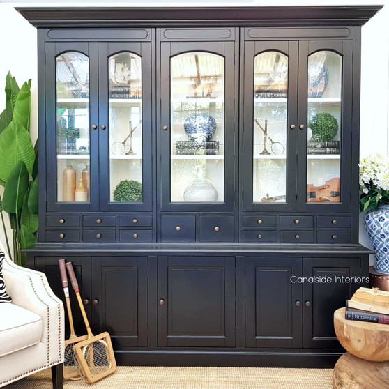 The Key Largo Display Unit in distressed black adds a timeless sophistication to your dining room, perfect for showcasing fine china – Canalside Interiors.