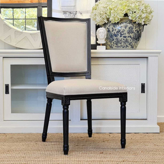 Stark Dining Chair - A French-inspired masterpiece with distressed black finish and cream upholstery, perfect for a Hamptons-style dining room - Canalside Interiors.