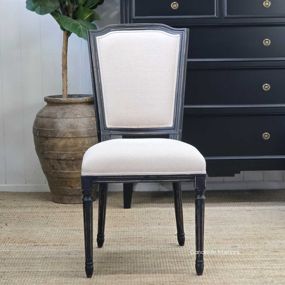 Angled close-up of the Stark Dining Chair showing the supportive backrest curve and fabric detail.