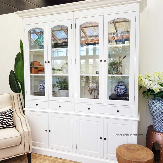 The Key Largo 4 Door Display Unit in distressed white offers a coastal charm, perfect for a Hamptons-inspired living room – Canalside Interiors