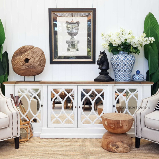 Front view of the Marielle Mirrored Sideboard in stone with heavy distressing and a weathered oak top, showcasing its unique circular overlay pattern on aged mirrored doors.