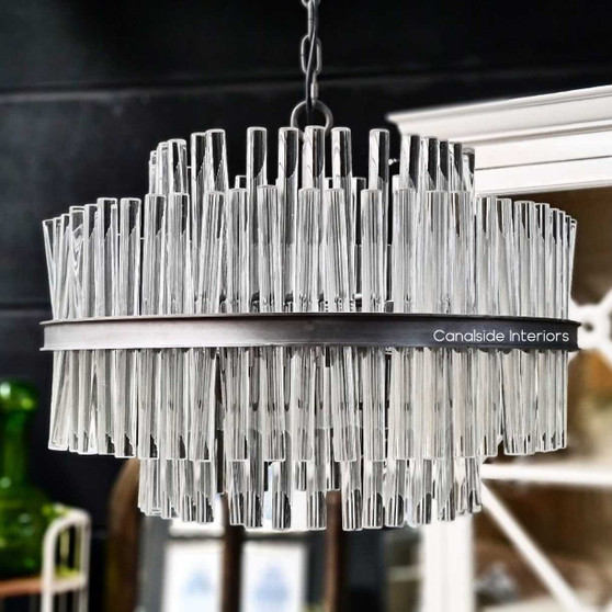Angled view of the chandelier, highlighting the geometric rod design and the luxurious lines reminiscent of the Art Deco era.