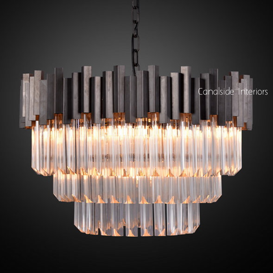 Canalside Interiors' Odeon Chandelier in Medium reflects a stunning array of light, ideal for bringing a timeless sparkle to a modern bedroom.