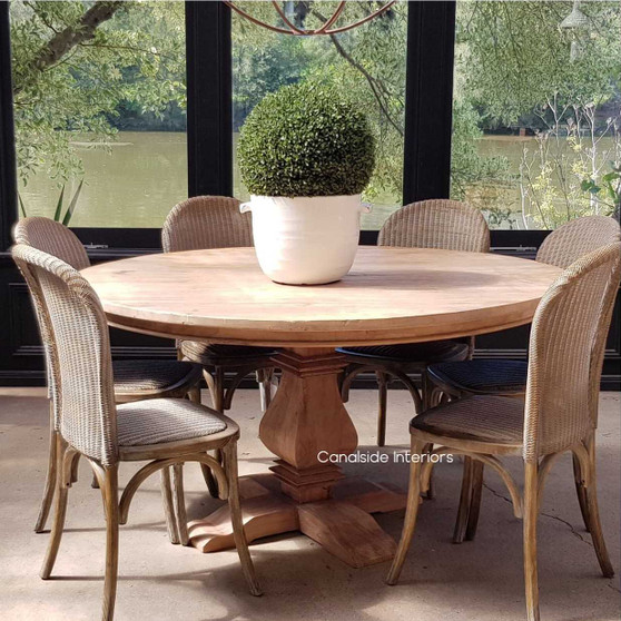 Front view of the Artisan Round Dining Table at Canalside Interiors, displaying its recycled timber craftsmanship and hand-carved pedestal base.