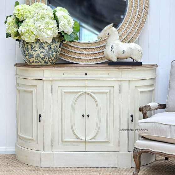 Canalside Interiors presents the Bastian Small Sideboard, blending a weathered oak top with a distressed stone finish, exemplifying classical Hamptons style.