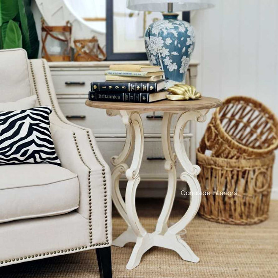 Angled shot of the side table, emphasizing the distressed stone finish and the intricate carvings, adding a touch of elegance to any coastal setting.