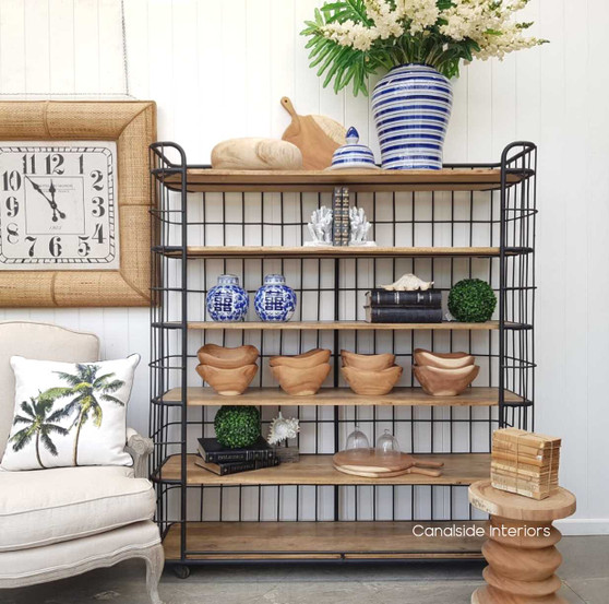 Front view of the Caged Baker's Wide Rack with distressed black industrial frame and rustic mangowood shelves.