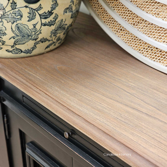 Frontal view of Bastian Small Sideboard in Distressed Charcoal Black featuring a weathered oak top, showing the classic curves and intricate detailing, perfect for adding a Hamptons touch to your bedroom or living room - Canalside Interiors.