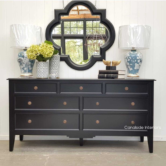 Front view of the Peninsula 7 Drawer Chest in black, showcasing its elegant design and minor distressing for a touch of charm