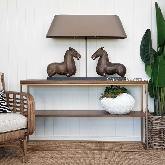 View of the Ancient Equestrian Table Lamp at Canalside Interiors, showcasing its walnut-finished horses and distressed black base.