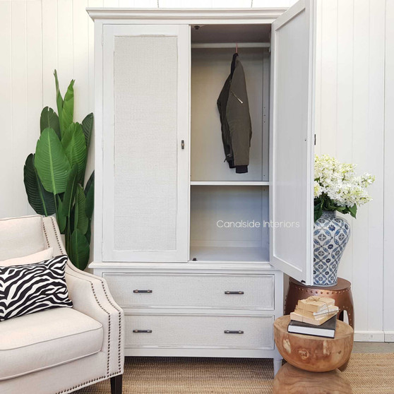 Frontal view of the Brielle Rattan Wardrobe Cupboard at Canalside Interiors, showcasing its distressed stone finish and stone rattan detailing.