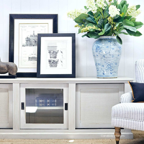 Front view of the Brielle Rattan Entertainment Unit II at Canalside Interiors, showcasing the intricate stone rattan detailing on a distressed stone finish