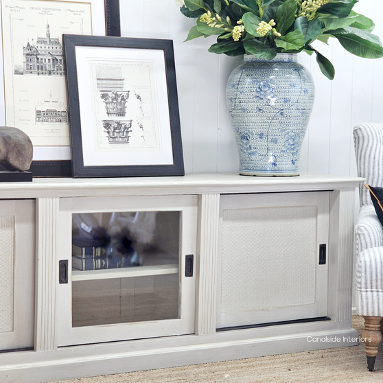 Front view of the Brielle Rattan Entertainment Unit II at Canalside Interiors, showcasing the intricate stone rattan detailing on a distressed stone finish
