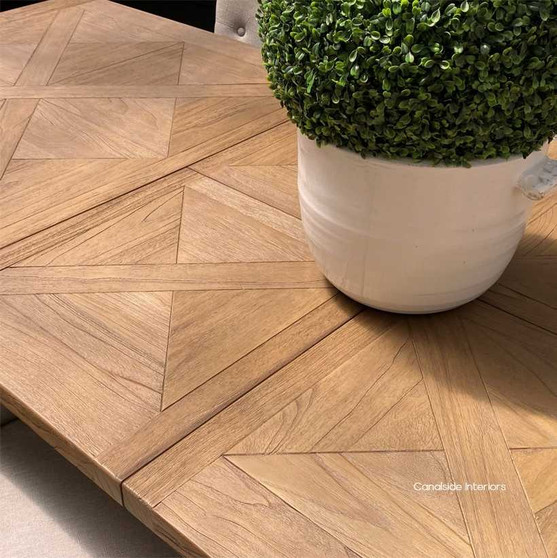 Front view of the Hampton Bay Parquetry Double Extension Dining Table closed position, showcasing its elegant parquetry top and solid fruitwood pedestal base.
