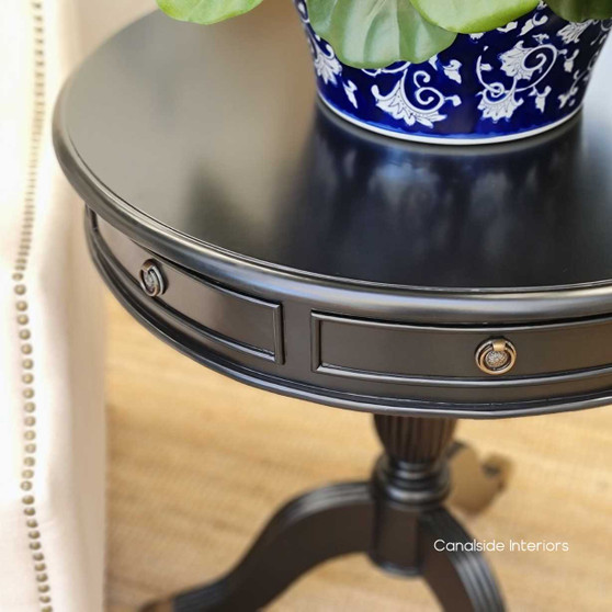 The Cobble Hill Large Round Table in a classic black finish from Canalside Interiors offers a modern take on timeless design, ideal for creating a welcoming entry in your front foyer