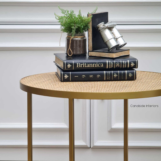 The Knox Rattan Side Table from Canalside Interiors, with its elegant gold frame, brings a modern yet classic flair to your bedroom setting