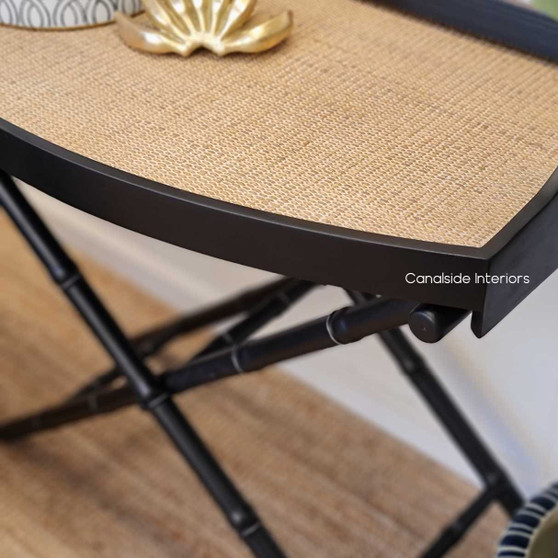 Distressed black Raffles Rattan Campaign Table with classic British Colonial charm for a stylish bedroom