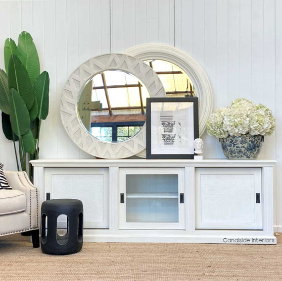The hand-carved Crabo Natural Stool/Side Table in distressed black from Canalside Interiors adds a bohemian luxe touch to your bedroom, blending seamlessly with coastal and classical themes
