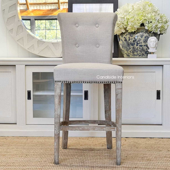 Angled view of the Montague Kitchen Bar Stool, emphasizing the harmonious blend of contemporary silhouette with classic button back detailing, ideal for quality-focused interiors.